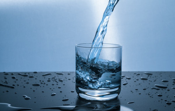 Image of a glass being filled with water